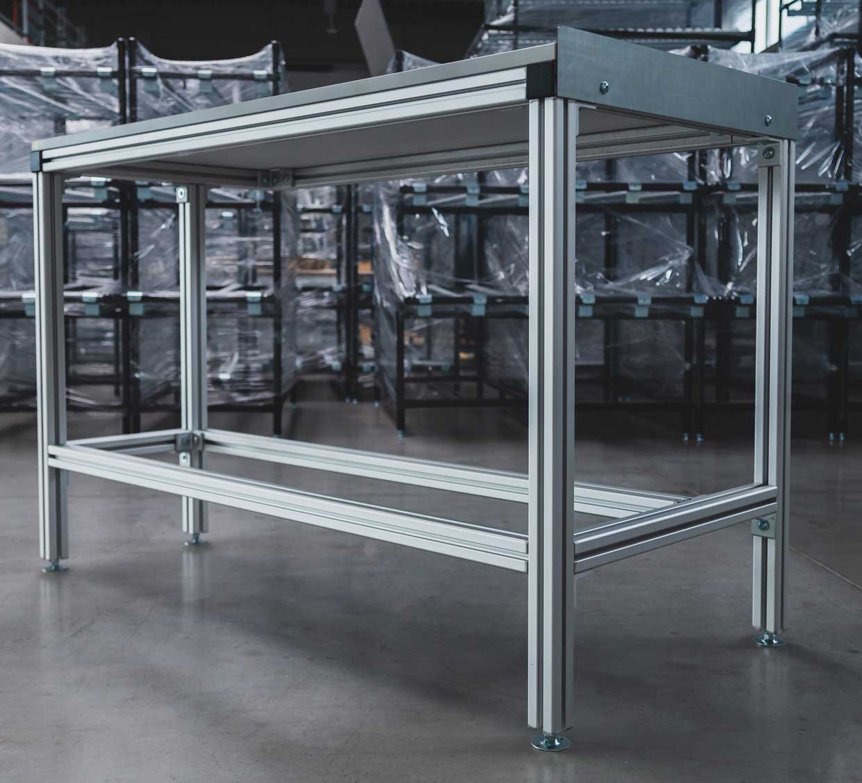 A stable table made of aluminum square pipes with height-adjustable feet.