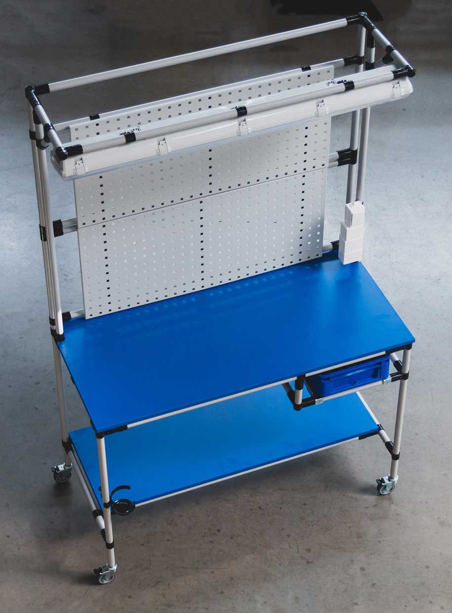 Mobile assembly workstation with a blue tabletop and a back panel made of perforated panels