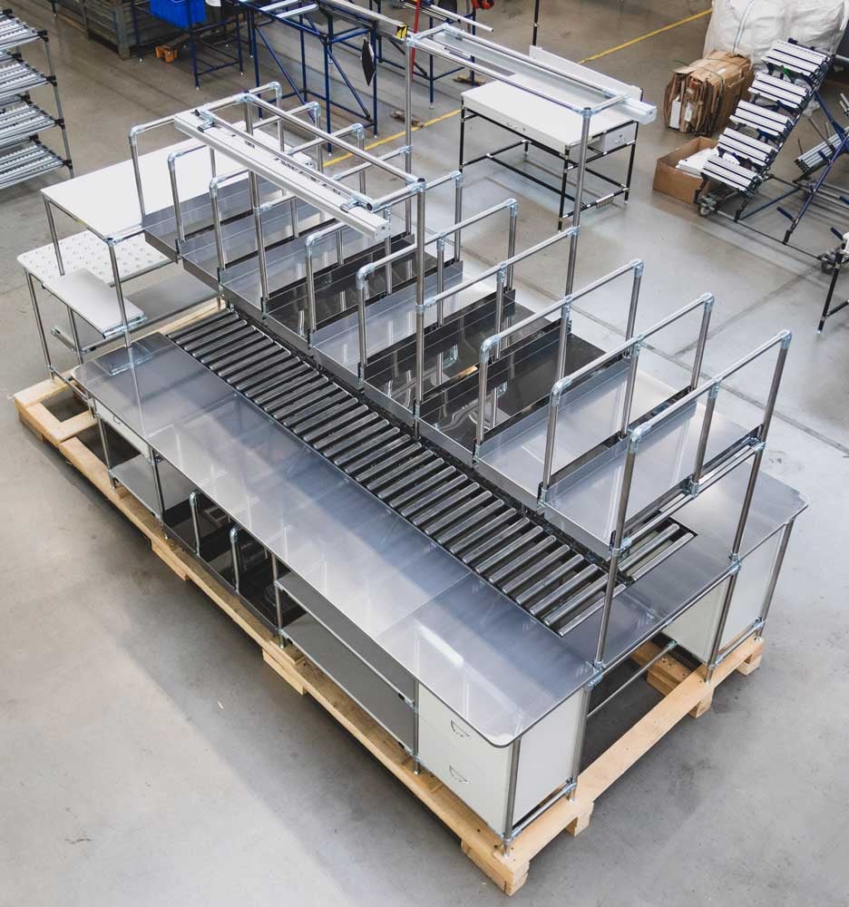 Assembly line with stainless steel-encased work surface and integrated cabinet systems
