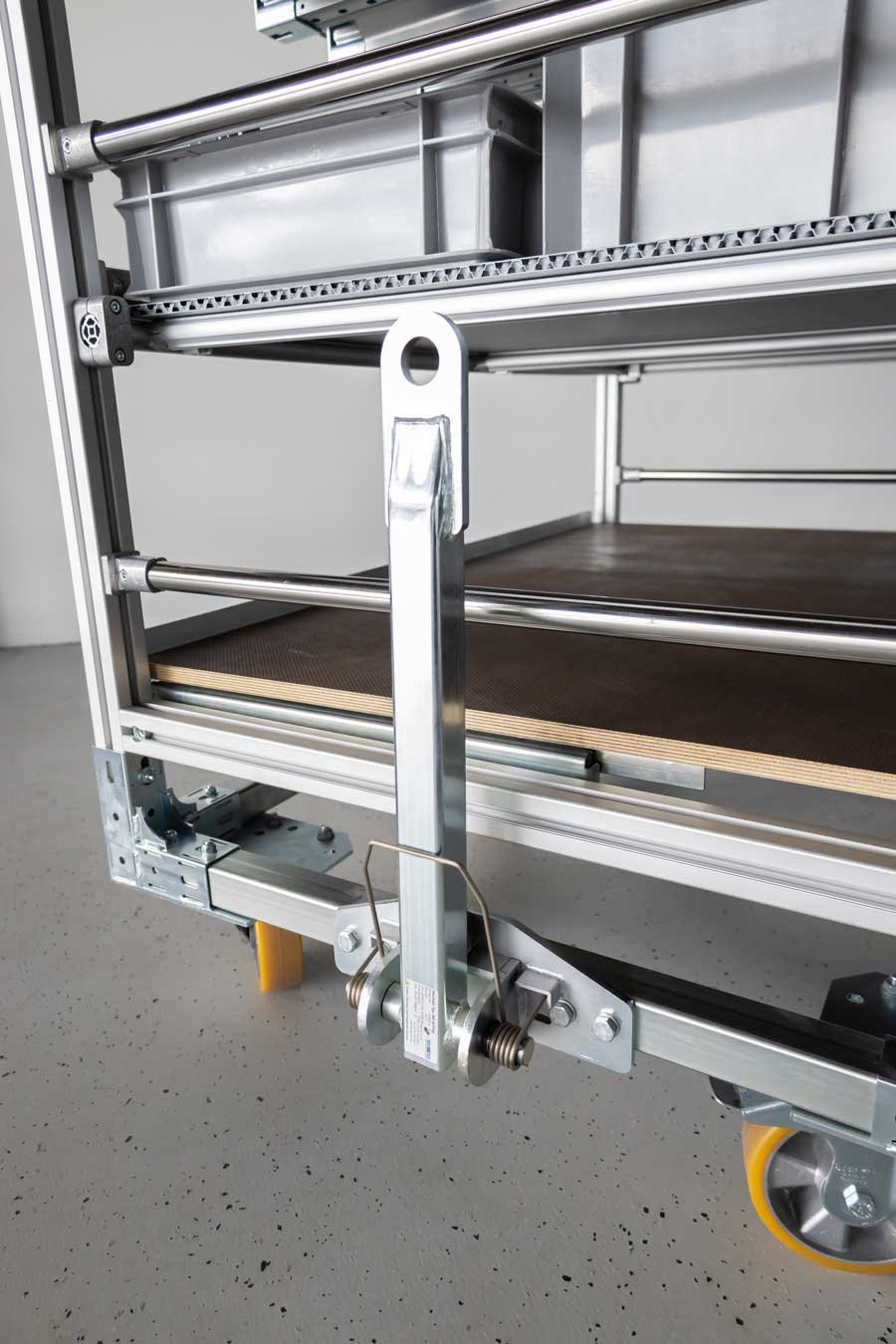 Spring drawbar on a transport trolley with several shelf levels on a base frame made of steel square profiles