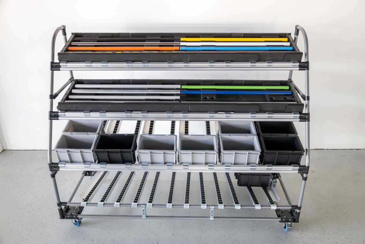 Movable shelf made of tube racking system with containers in various designs on several levels. 