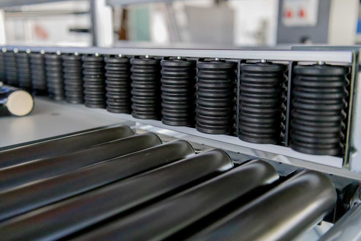Roller conveyor embedded in the worktop as a connecting element within an assembly line