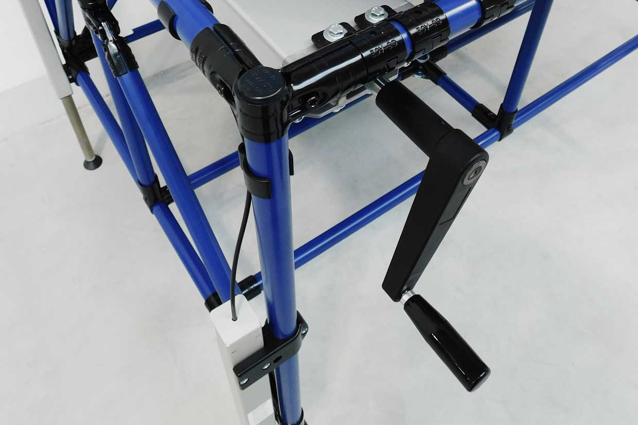 Hydraulic lifting system with crank on a workstation made of blue round pipe